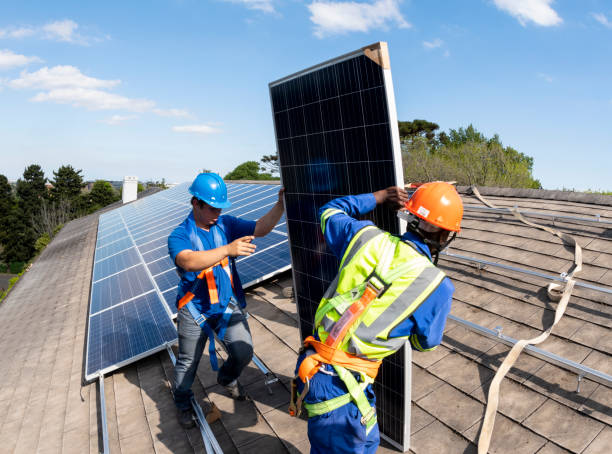 istock Men moving solar panels on rooftop for installation 1414619008