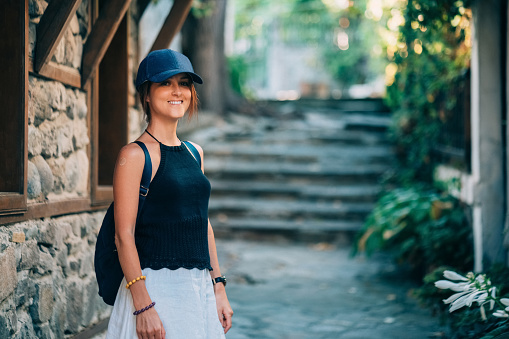 Smiling woman visiting an old town in Eastern Europe