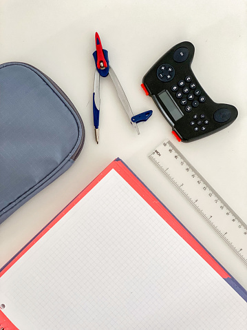 Desk table with notebook, pencil case, calculator and drawing compass