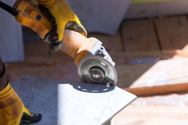 istock On a ceramic tile floor, a construction worker uses a tool to cut the tiles and lay them with the help of the equipment 1414621265