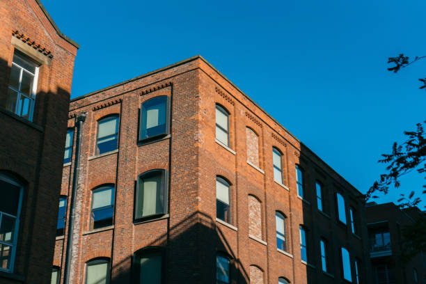 istock Buildings in Manchester city centre with blue sky brickwork backstreets 1414623020
