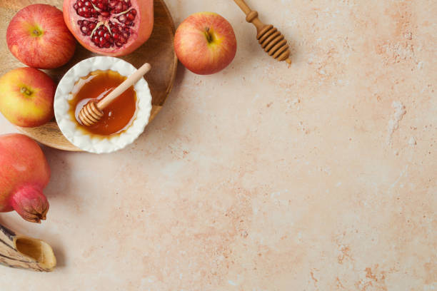 Jewish holiday Rosh Hashanah concept. Honey, apple and pomegranate on stone background. Top view, flat lay Jewish holiday Rosh Hashanah concept. Honey, apple and pomegranate on stone background. Top view, flat lay rosh hashanah stock pictures, royalty-free photos & images