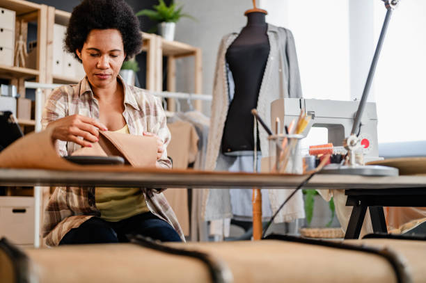 istock Young black entrepreneur women working in her workshop. Woman tailor 1414626003