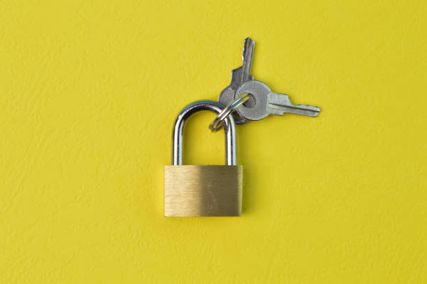 istock Padlock and keys isolated on a yellow background 1414627657