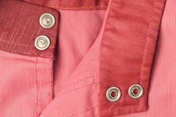 istock Close up view of silver buttons on cloth 1414628225