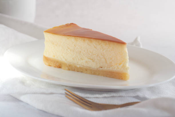 istock A piece of caramel cheesecake on a saucer on a light table. 1414631180
