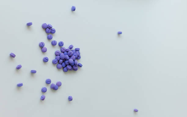 istock Scattered blue pills on a white background. Dental plaque detection tool 1414633382