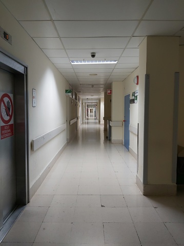standing in a hospital hallway, medical treatment and health care