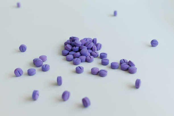 istock Scattered blue pills on a white background. Dental plaque detection tool 1414633494