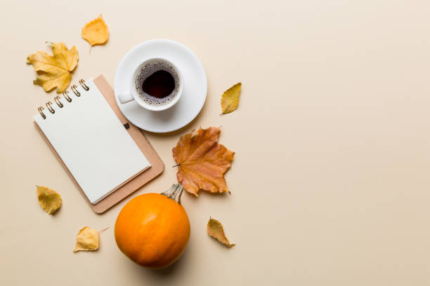 istock Autumn composition: fallen leaves and notebook mock up on colored background. Top view. Flat lay with copy space 1414636816