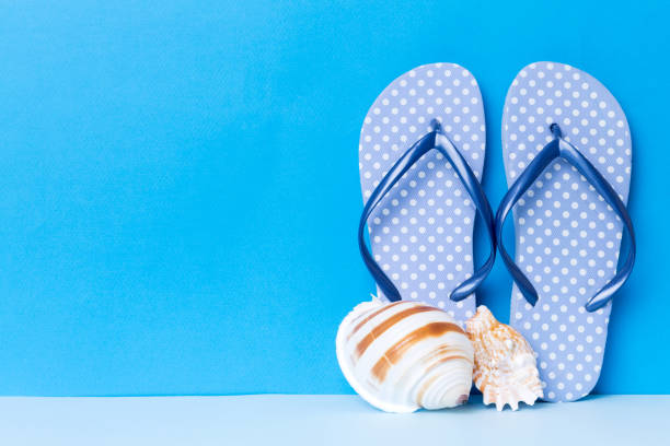 istock Beach accessories. Flip flops and starfish on colored background. Mock up with copy space 1414636869