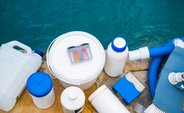 From Above Photo Of Outdoor Pool Cleaning Set And Maintenance Tools High angle view of equipment for testing the quality of pool water, vacuum cleaner and chemical cleaning products at the edge of swimming pool. chlorine stock pictures, royalty-free photos & images