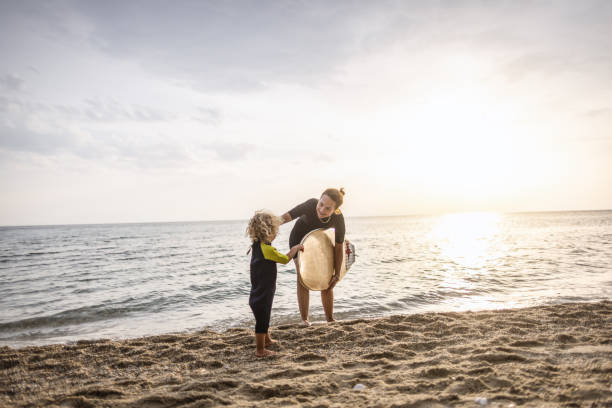 istock Surfing mum and son leave the water together 1414638420