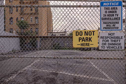 A warning sign Danger Asbestos on a fence at site rehabilitated post asbestos contamination