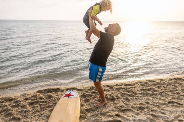 istock Playful father with his boy at the beach 1414638873
