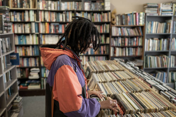 istock Woman searching through vinyl records 1414640386
