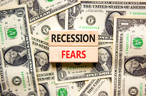 Recession fears symbol. Concept words Recession fears on wooden blocks on a beautiful background from dollar bills. Business and recession fears concept. Copy space.