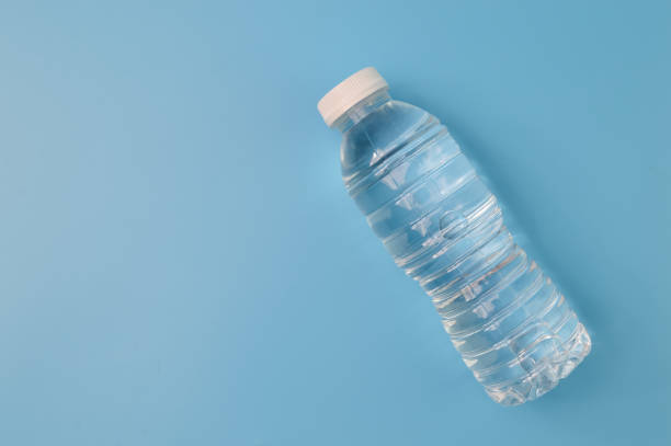 istock Plastic bottle with water isolated on a blue background 1414647706