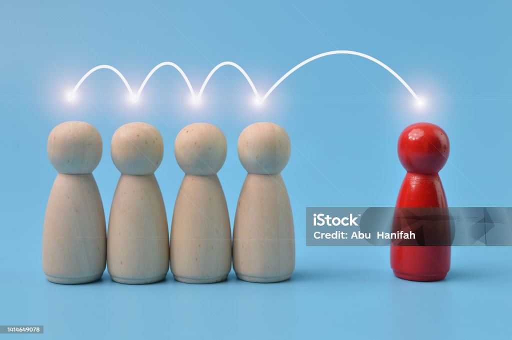 The red human figure is connected by lines with four peoples. Business management, leadership, teamwork, cooperation and collaboration concept. Adult Stock Photo
