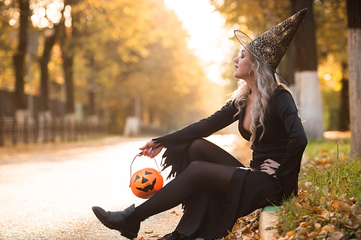 Halloween holiday. Preparation for the holiday. A Halloween party. Portrait of a woman in a witch costume.