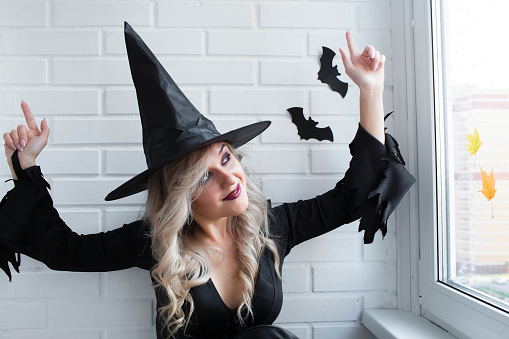 Halloween holiday. Preparation for the holiday. A Halloween party. Portrait of a woman in a witch costume.