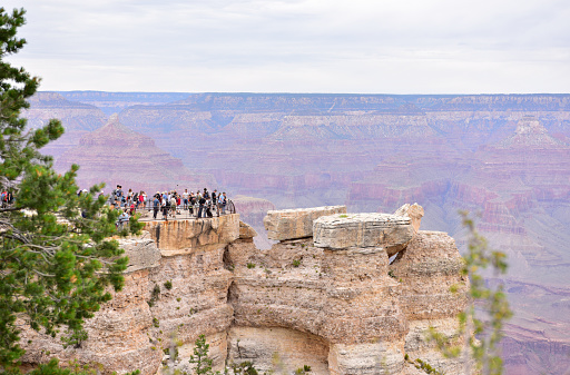 Tourists overlook the Grand Canyon from Mather Point tourist stop in the South Rim of the Grand Canyon National Park. Arizona, Usa, America.