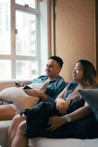 istock couple at home watching tv 1414653488