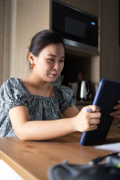 istock person reacting at a video on tablet 1414653567