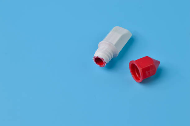istock Red watercolor isolated on a blue background. Copy space for the text 1414657035