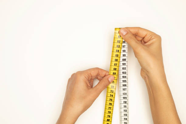 Woman holding tape measure.