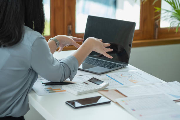 istock Businesswoman presenting profit data with graphs to her supervisor via laptop computer. 1414660711