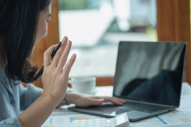 istock Businesswoman presenting profit data with graphs to her supervisor via laptop computer. 1414660732
