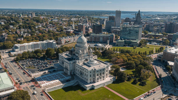 Rhode Island State House in Providens on Capitol Hill, with a remote view of Downtown Providence and Providence River in the backdrop. stock photo