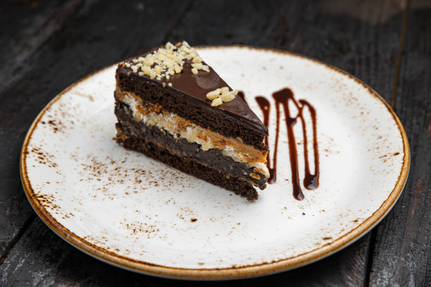 istock chocolate cake with cream  on a wooden background 1414669516