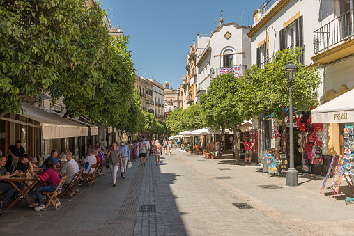 seville, spain-may, 17, 2022: small narrow street in the historic old town of Seville, Spain