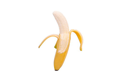 Yellow, half-peeled banana, isolated on a white background