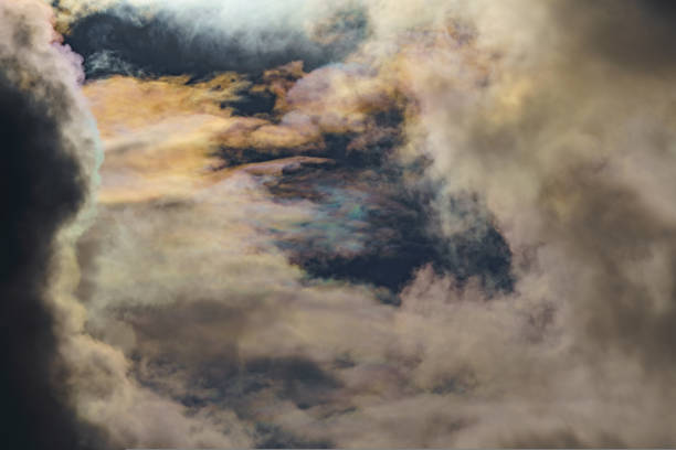 istock Diffraction of light on drops of supercooled water in clouds, rainbow clouds against the blue sky in clear sunny weather, irisation of cumulus clouds, optical phenomenon, spectral colors 1414678307
