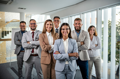 Confident businesswoman and her team