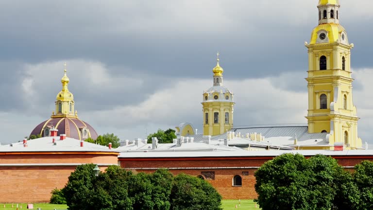 angel on the golden spire of the Peter and Paul Cathedral on the territory of the fortress, stormy sky in the background