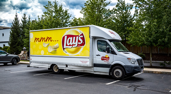 Potato Chip delivery truck in the parking lot of a small suburban Boston shopping plaza.
