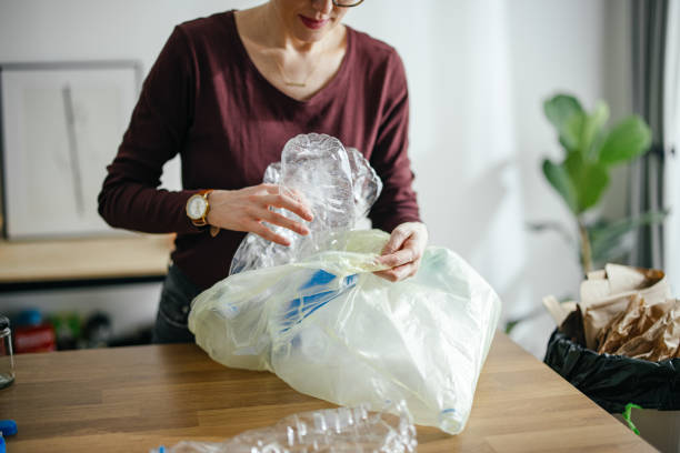 istock Unrecognizable Woman Recycling Empty Plastic Bottles At Home 1414682630