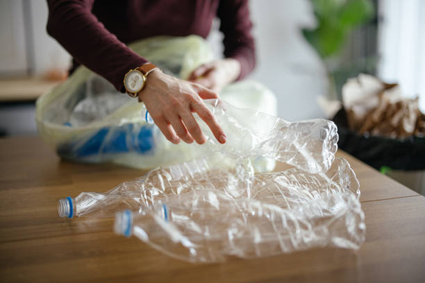 istock Unrecognizable Woman Recycling Empty Plastic Bottles At Home 1414682637
