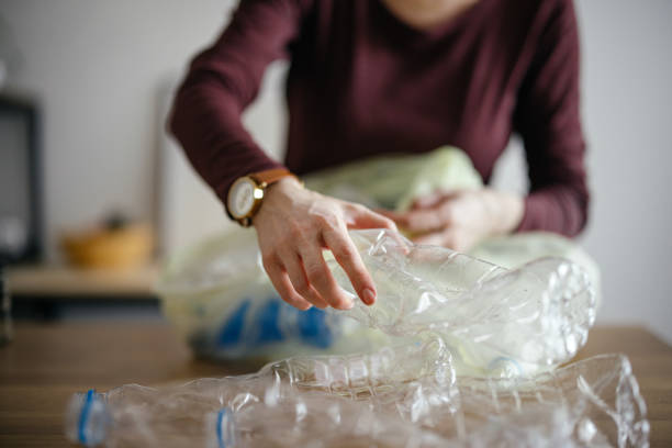 istock An Anonymous Woman Recycling Empty Plastic Bottles At Home 1414682645