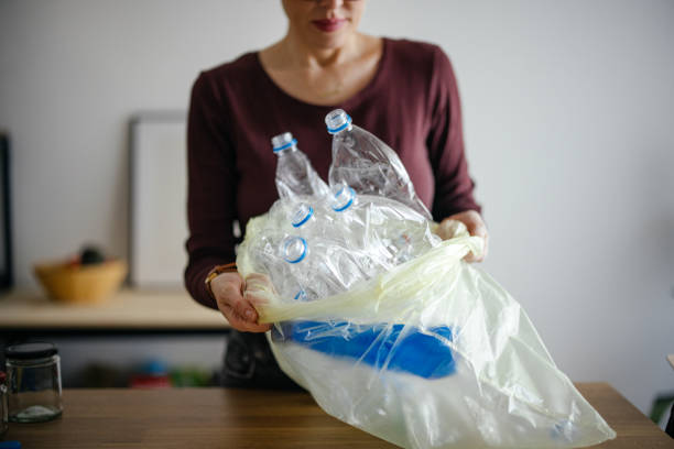 istock Unrecognizable Woman Recycling Empty Plastic Bottles At Home 1414682657