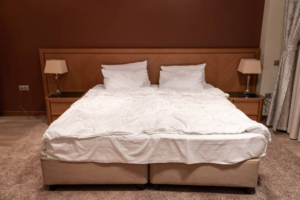 istock King size bed in hotel room with bedside tables and lamps 1414688933