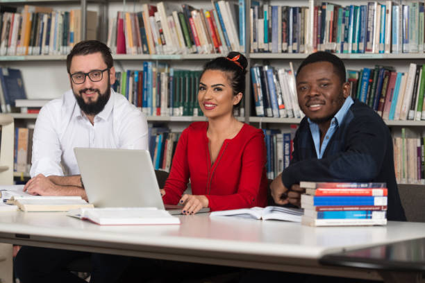 istock Group Of Young Students Studying Together At College 1414688990