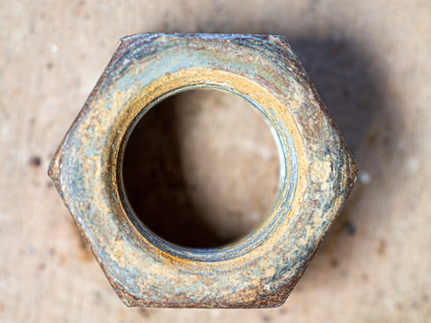 Close up image of a rusty, old-fashioned door knob on an ancient, Gothic-style doorway.