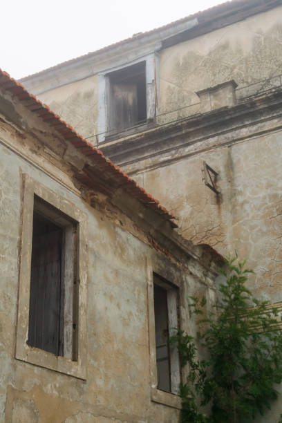 istock Abandoned building with empty windows in the fog 1414689773