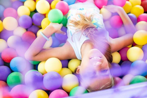 Girl in a T-shirt spends time in the playroom enjoying a summer day stock photo