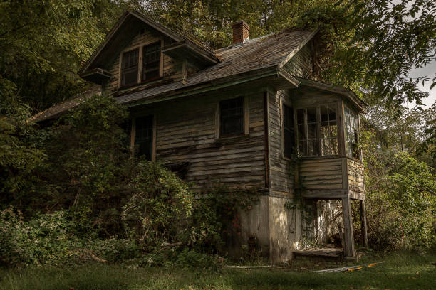 Steep Rock, Manitoba, September 29, 2010:  A weathered farmhouse stands proudly amid rolling fields, its aged wooden planks faded to a soft gray, bearing the marks of time and seasons past.  The farmhouse exudes quiet resilience, a sanctuary of warmth and history, embraced by the splendor of autumn's final fiery display.